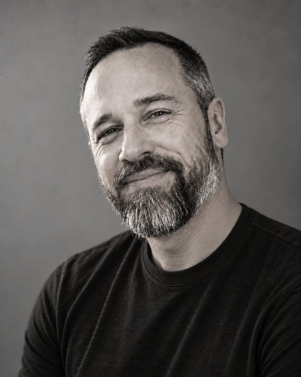 Ran Craycraft, smiling, in a black t-shirt